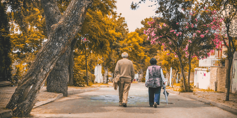 wound care and senior couple on a walk down the street